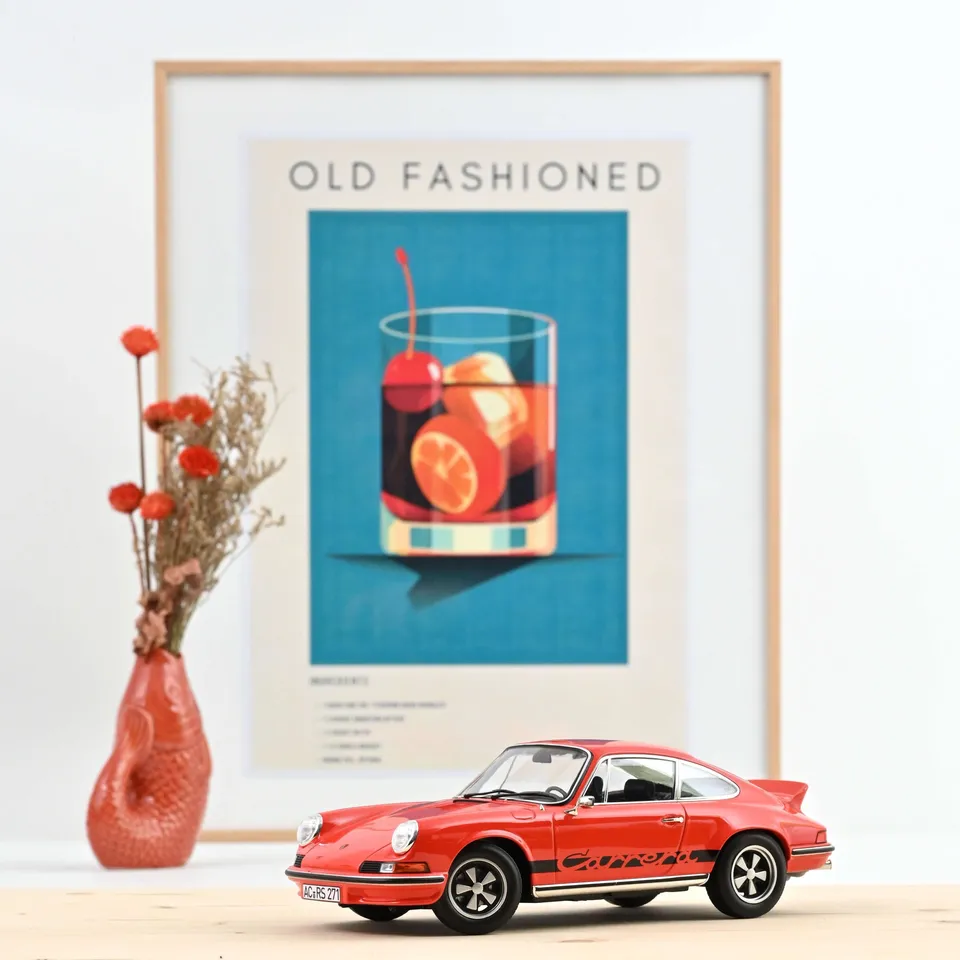 norev-porsche-911-rs-1973-arancione-nero-modellino-auto-1-18-300-pz image 1